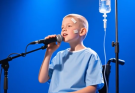 He Rolled Onto the Stage in a Wheelchair, Covered in Bandages—What This Brave Boy Sang Next Left the Entire Room in Tears